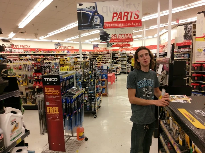 Customer in an auto parts store aisle.