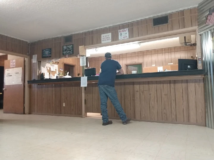 Customer at the counter of David's Auto Salvage.