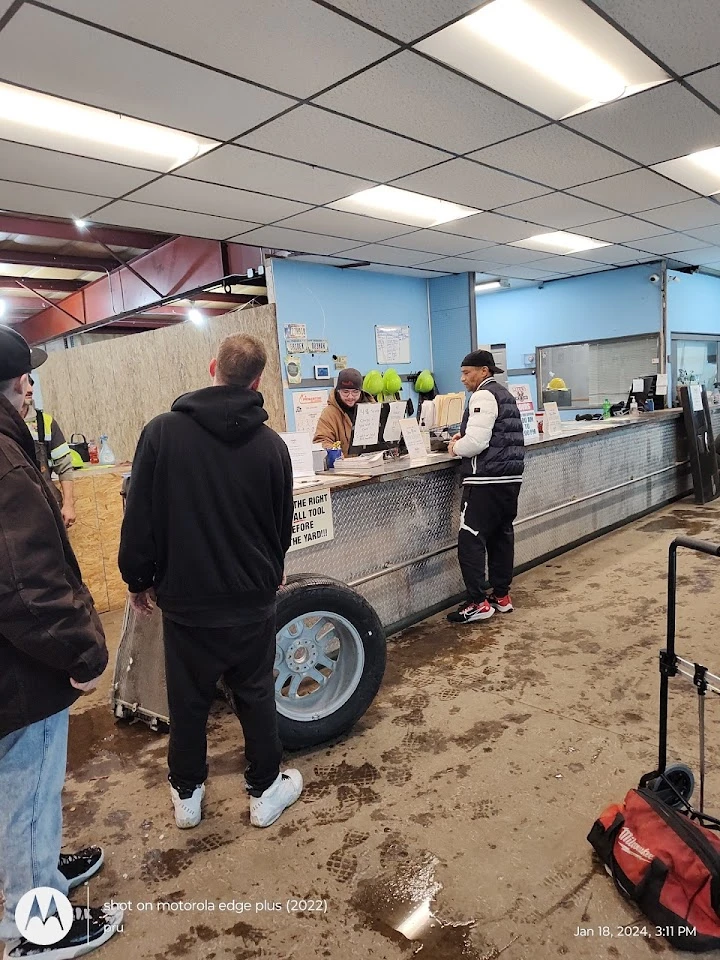 Customers at the service counter in an auto yard.