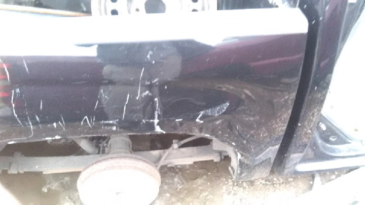 Damaged side of a vehicle showing scratches.