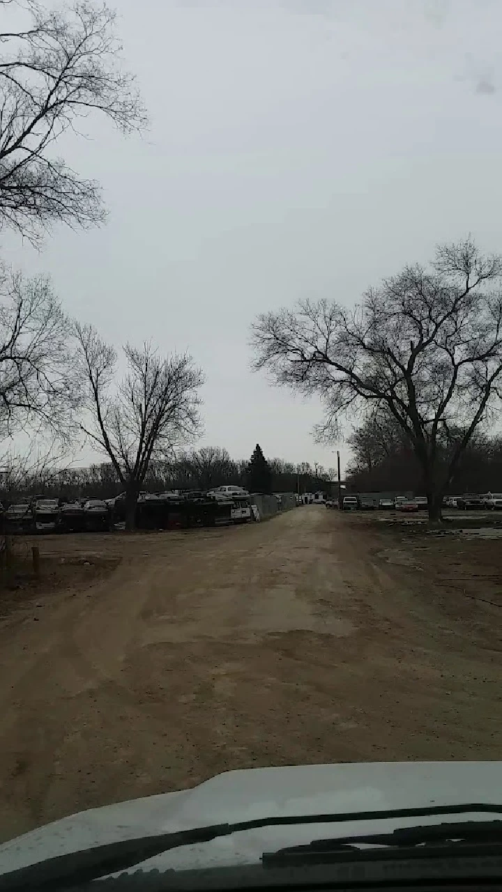 Dirt road leading to Aikey Auto Salvage yard.