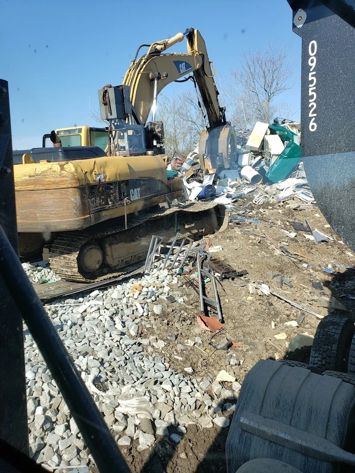 Excavator working at a scrap recycling site.