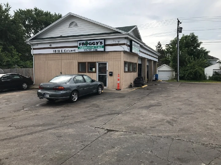 Froggy's Automotive Care location with parked cars.