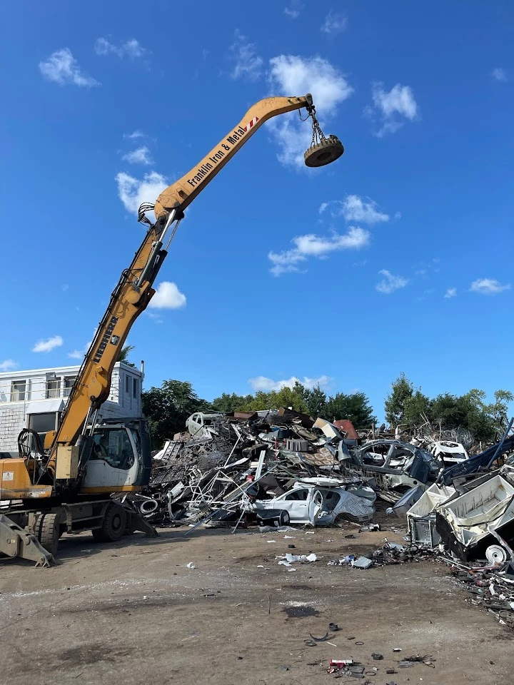 Heavy machinery at a metal recycling yard.