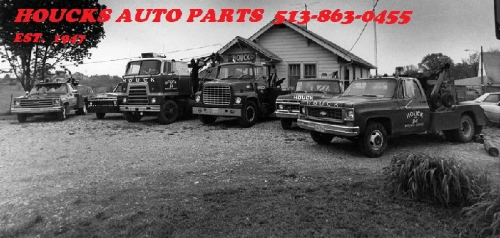 Historic image of Houck's Auto Parts with trucks.