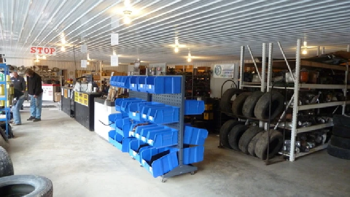 Inside view of an auto salvage shop with parts.