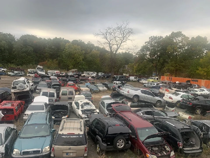 Junkyard filled with various used vehicles.