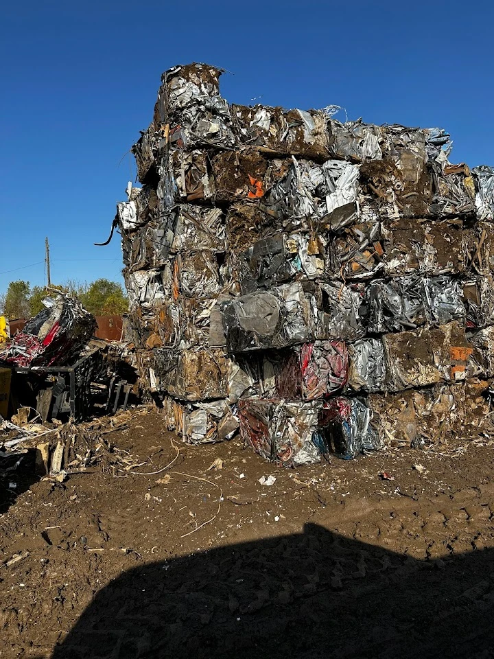 Metal scrap bales stacked at a recycling facility.