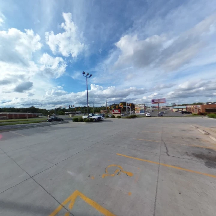 O'Reilly Auto Parts storefront with cloudy sky.