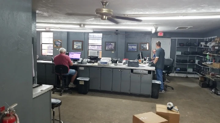 Office interior with two people working at desks.