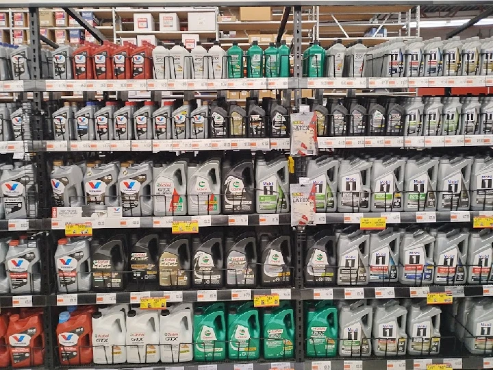 Oil bottles displayed on a store shelf.