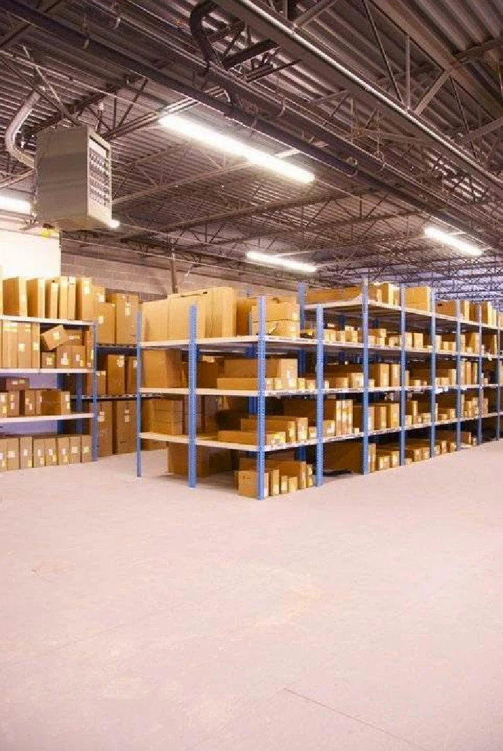 Organized warehouse with stacked boxes on shelves.