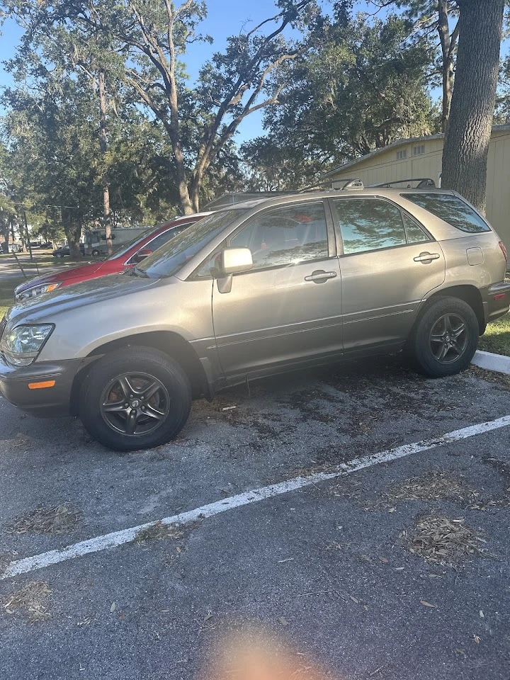 Parked SUV in a tree-lined lot.