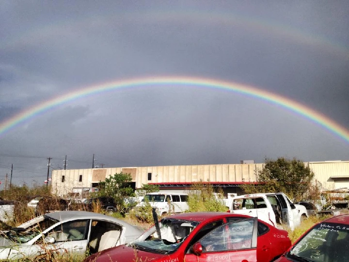 Rainbow over a junkyard at C & D Auto Parts.