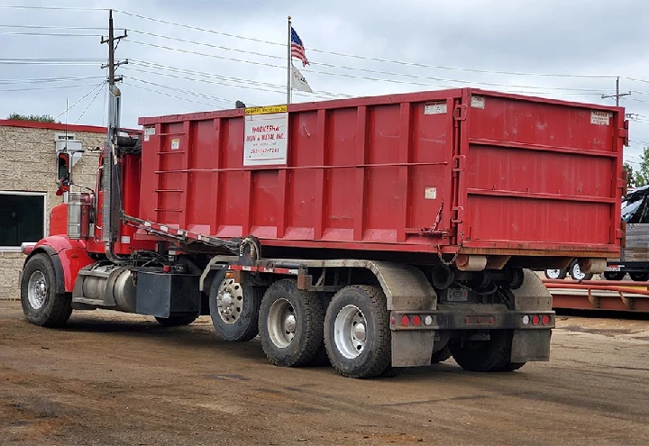 Red truck with metal container at Waukesha Iron & Metal.