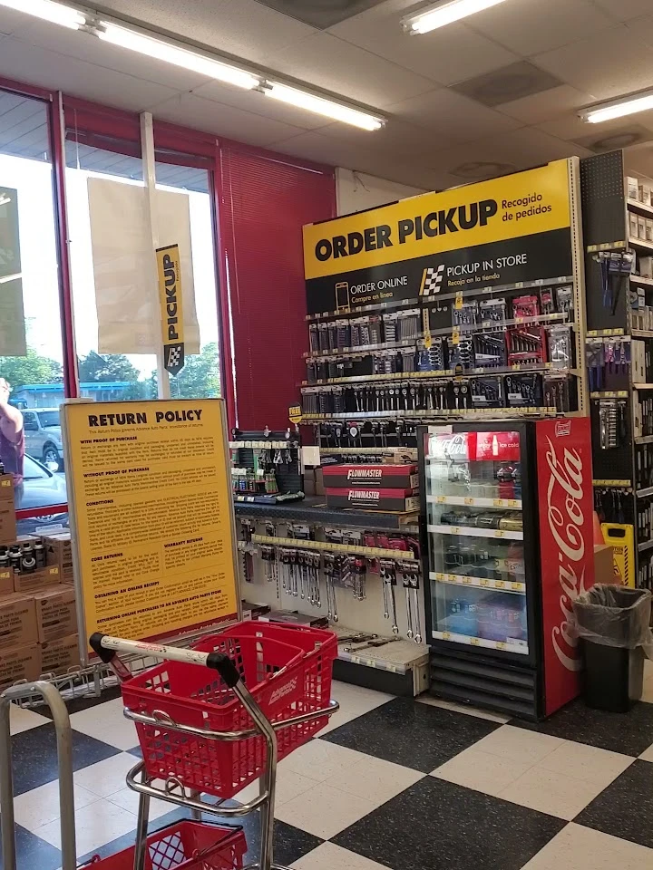 Retail store interior with pickup and return signs.