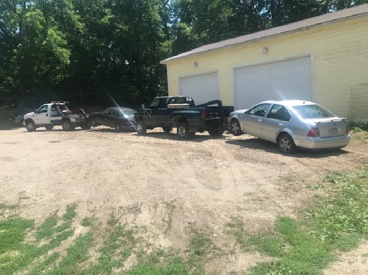 row of junk cars beside a building