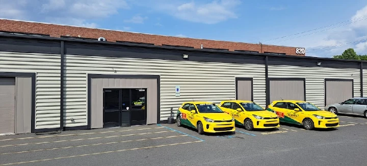 Scranton AutoParts Warehouse exterior with yellow cars.