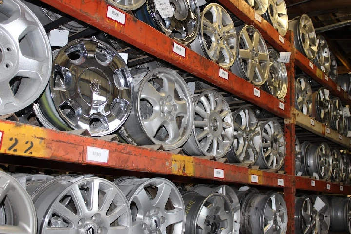 Shelves of auto wheels at Waterloo Auto Parts Salvage.