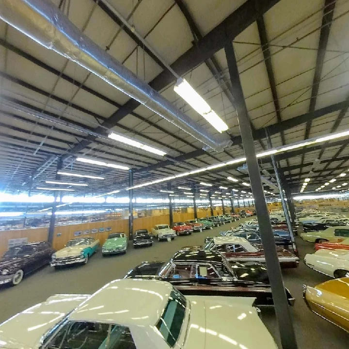 Showroom filled with classic cars at National Parts Depot.