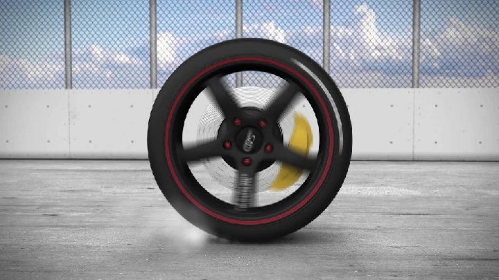 Spinning car tire with red accents and brake rotor.