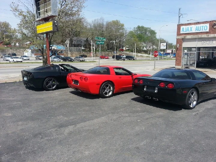 Three sports cars parked outside Ajax Auto Parts Inc.