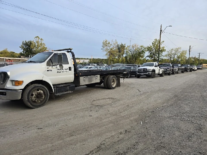 Tow truck and parked vehicles at Apex Auto Salvage.