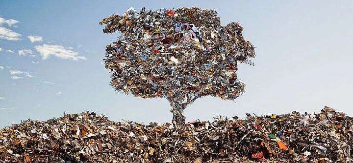 Tree made of recycled materials on a scrap heap.