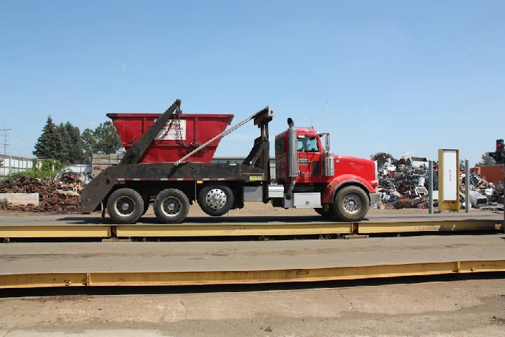 Truck unloading scrap metal at Waukesha Iron & Metal.