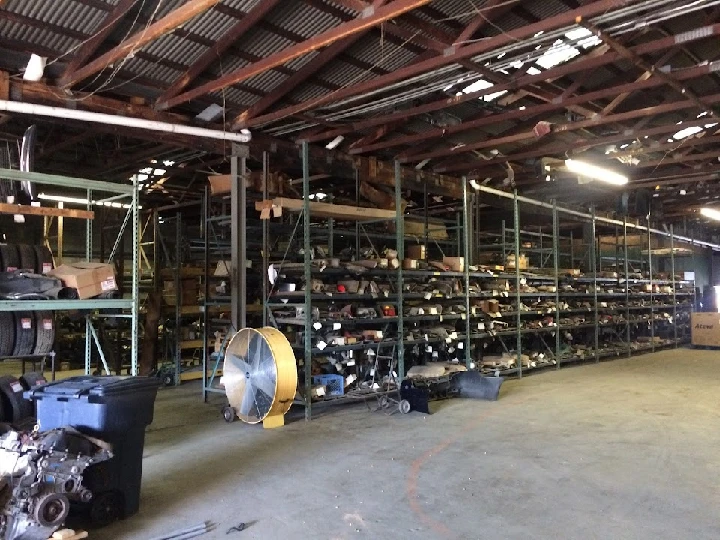 Used auto parts storage facility with shelves stocked.