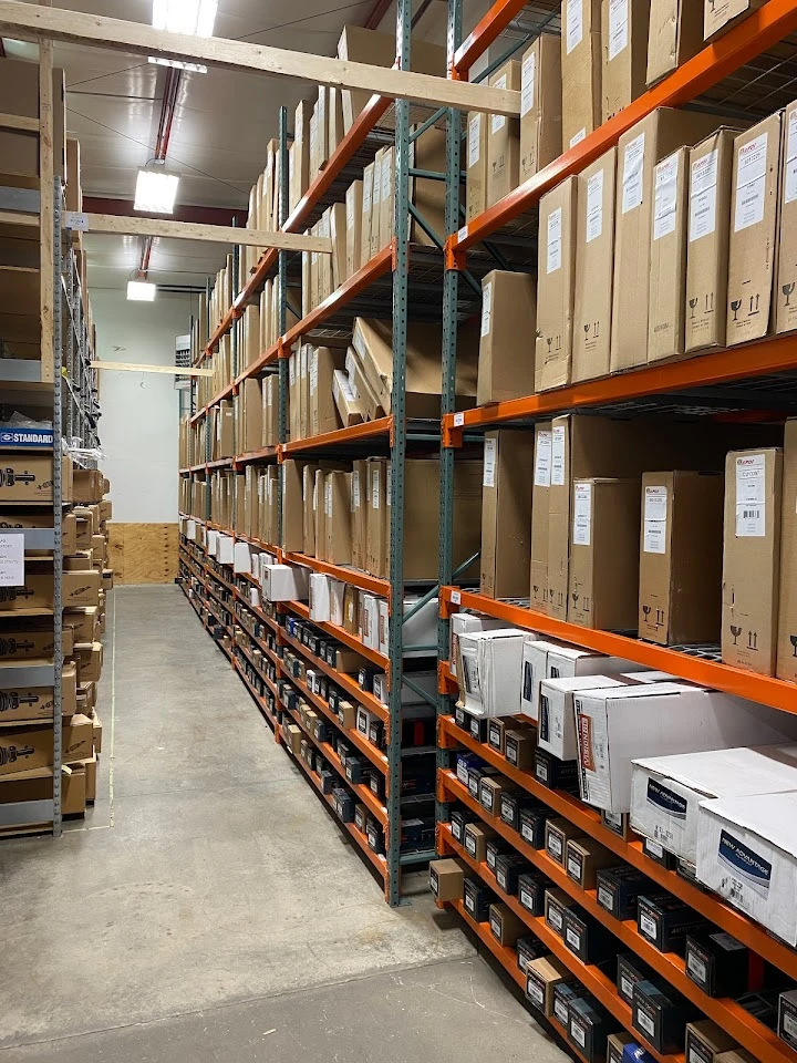 Warehouse stocked with auto parts in organized shelves.