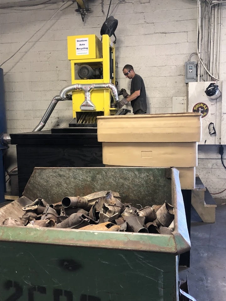 Worker operating machinery at Stanton's Auto Recycling.