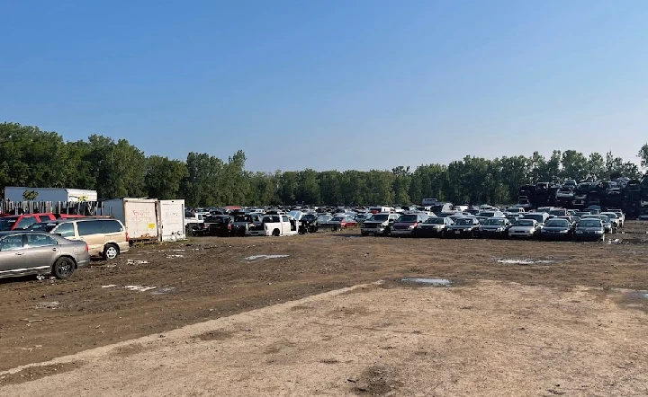 Aerial view of a junkyard filled with cars.