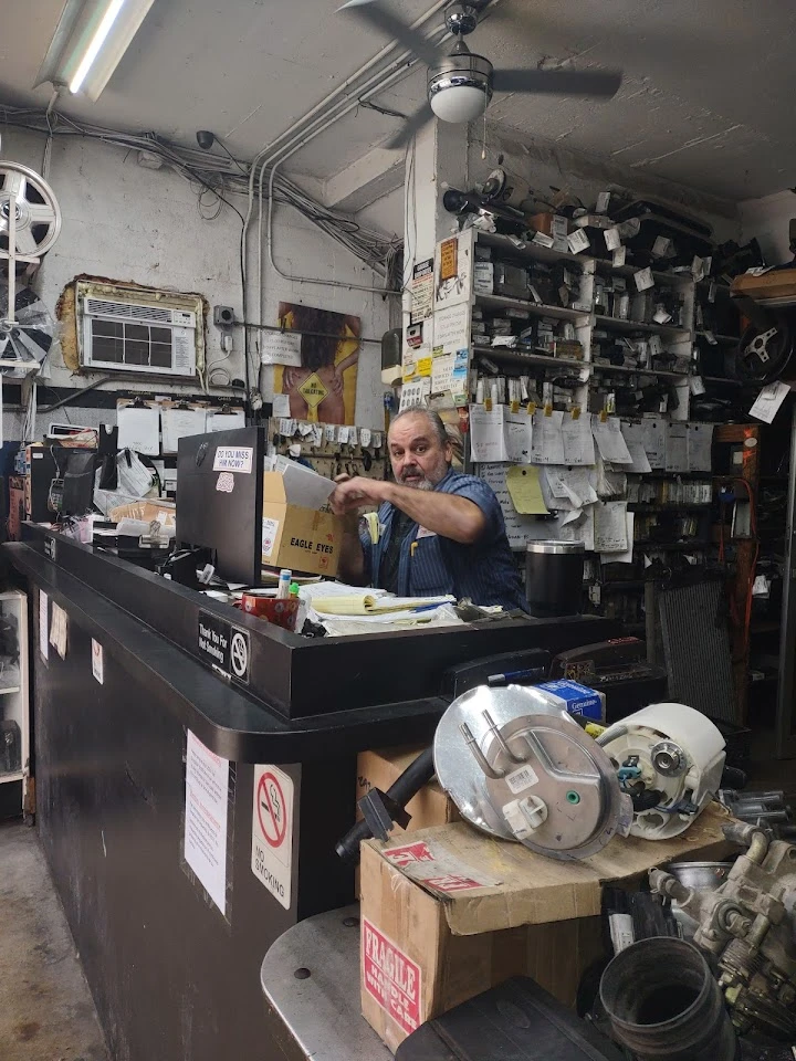 Auto parts counter with staff and tools visible.