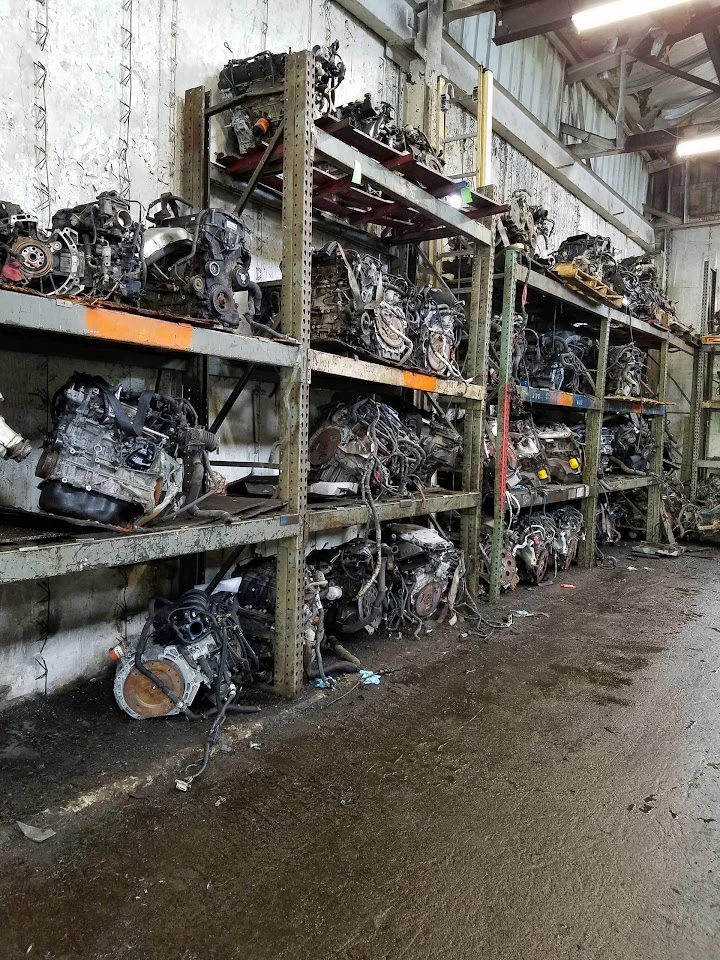 Auto parts inventory with stacked car engines.