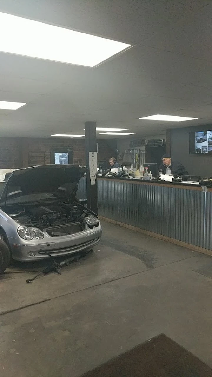 Auto parts shop with a car being serviced inside.