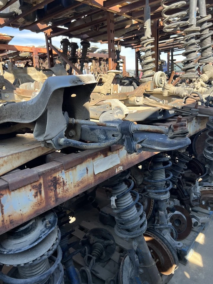 Auto parts stacked in a salvage yard.