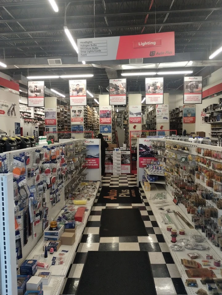 Auto parts store aisle with various products displayed.