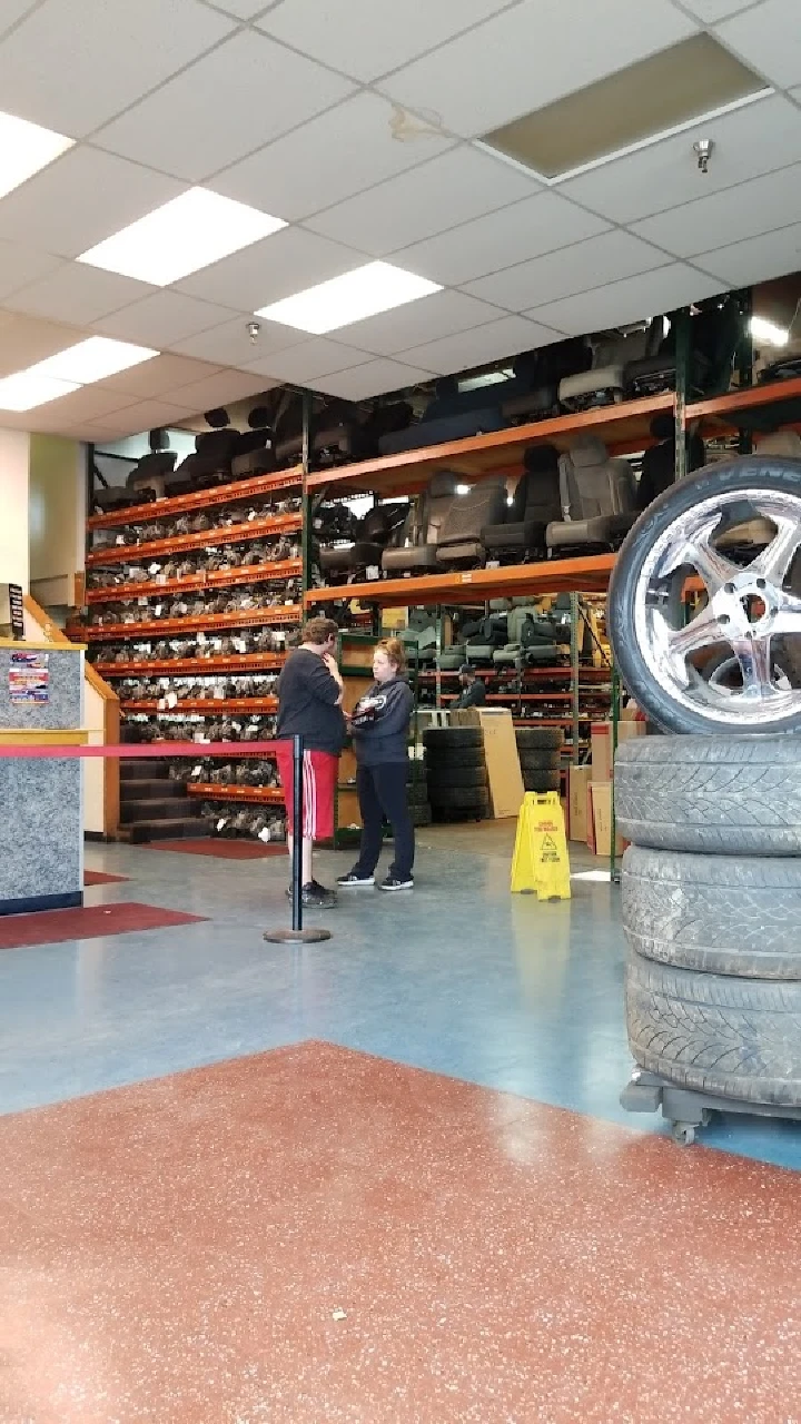 Auto parts store interior with customers talking.