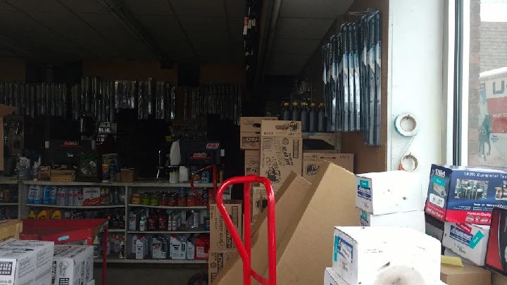 Auto parts store interior with shelves and boxes.