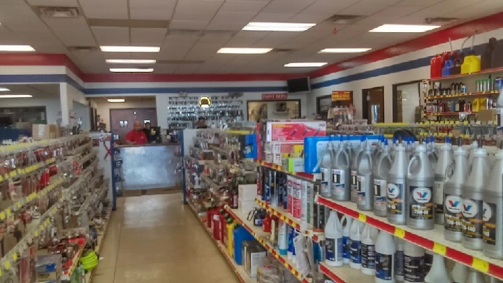 Auto parts store interior with stocked shelves.