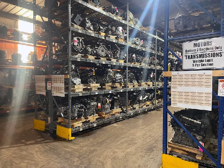 Auto parts warehouse with shelves of engines.