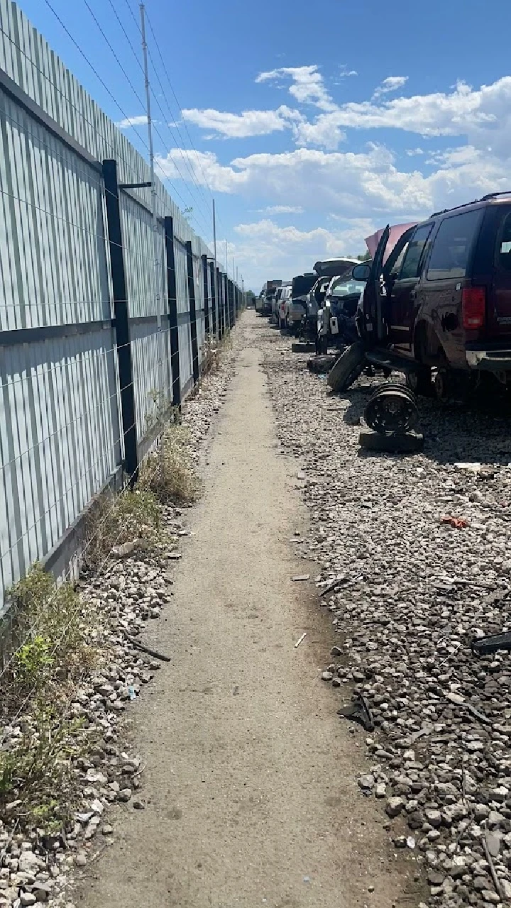 Auto recycling yard with abandoned vehicles.