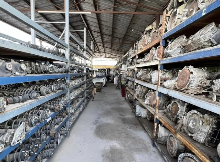 Auto salvage yard with shelves of car parts.