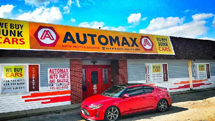 AUTOMAX Auto Parts and Salvage storefront with car.