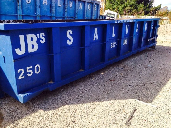 Blue dumpster with JB's Salvage logo printed.