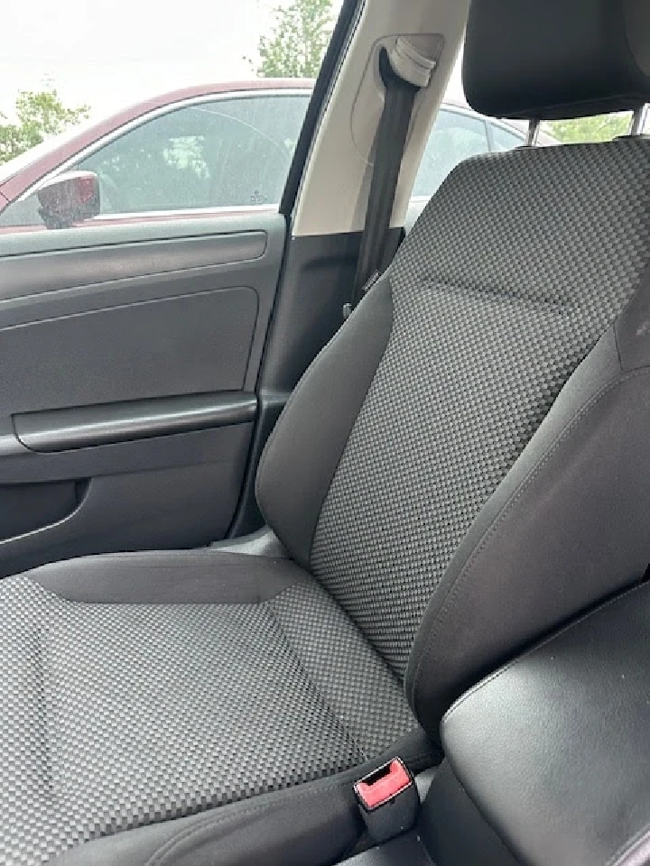 Car interior featuring a black fabric seat.