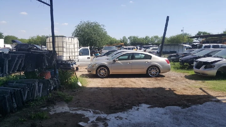 Cars and auto parts in a junkyard setting.