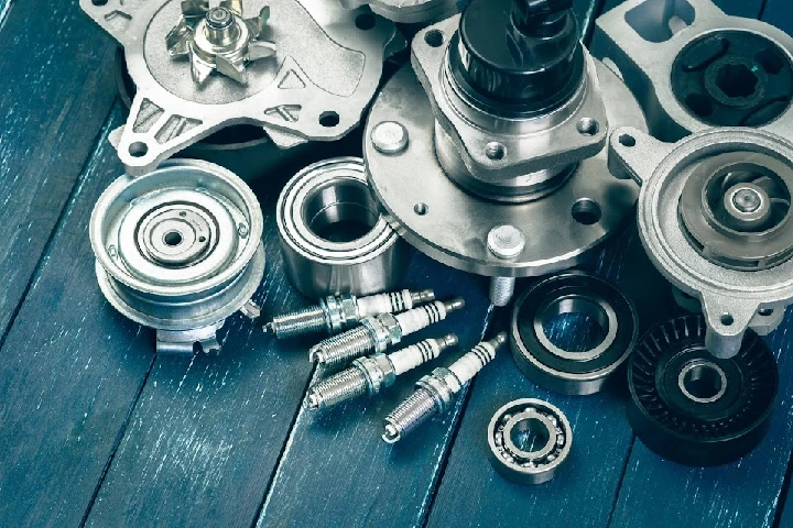 Collection of auto parts on a wooden surface.