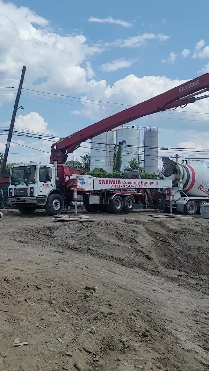 Concrete pump truck on an outdoor worksite.